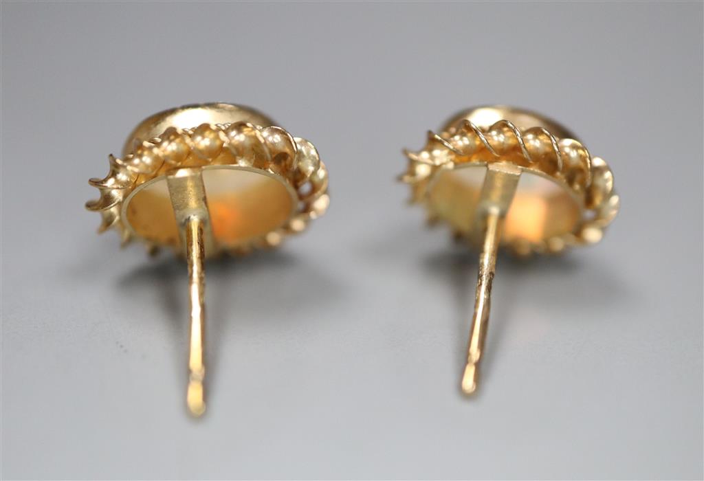A modern pair of 9ct gold and white opal oval earrings, no butterflies, gross 1.1 grams.